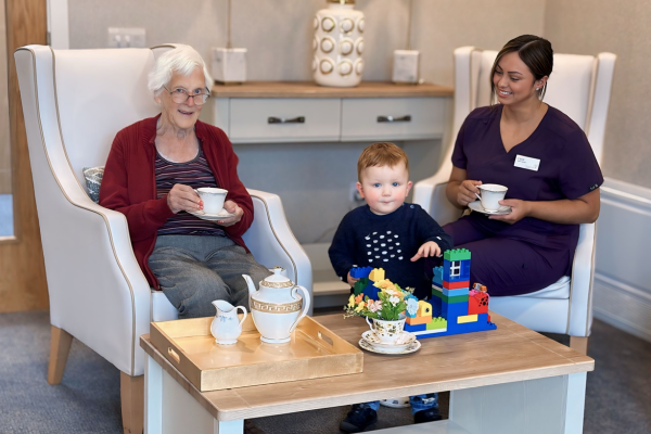 Resident Kay Drought, Hector, and deputy manager Lucia Matheson at the launch of 'Tea and Tots' in Eilean Dubh, Fortrose.